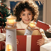 Child opening a gift box with a lighthouse toy inside, surrounded by festive decorations.