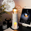 Lighthouse-shaped lamp on a table with a tablet displaying its app interface, moon visible in the background.