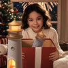 Child with a lighthouse toy and Christmas tree in the background