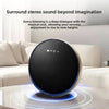 Round black speaker with brand logo on a white surface, text about surround stereo sound.