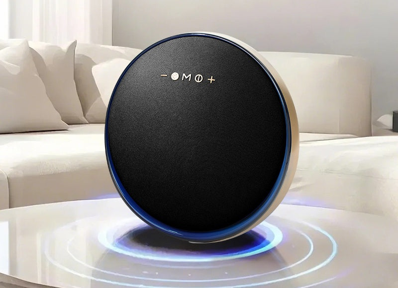 Round robot vacuum cleaner on a white surface with a light-colored couch in the background